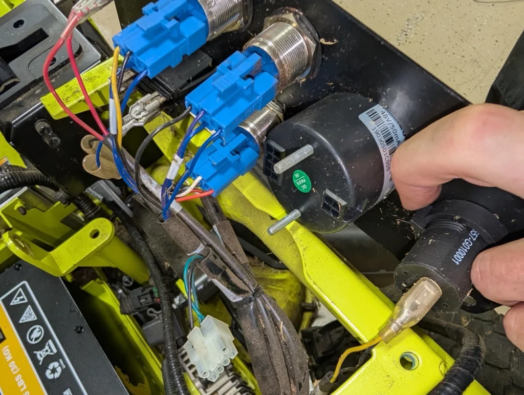 Close up view of the new Qomo Energy state-of-charge meter being installed into the Ryobi electrical panel.